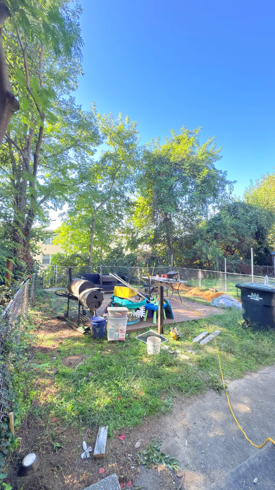 Backyard before renovation: bare dirt, debris and old fencing in Southeast Washington DC